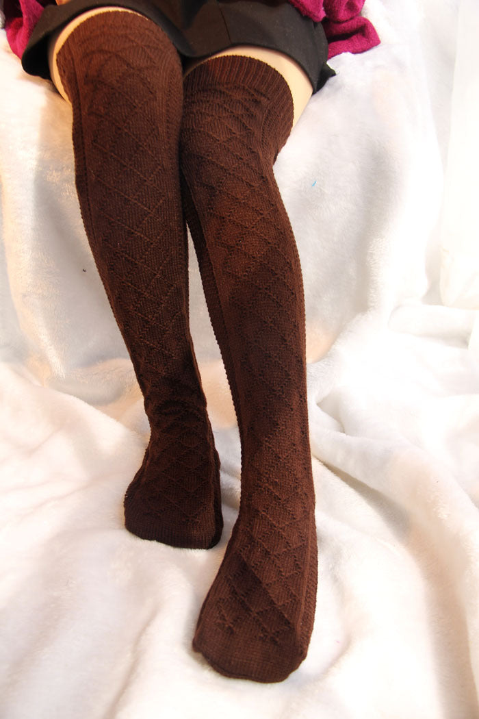 Brown knitted knee-high socks on a white surface