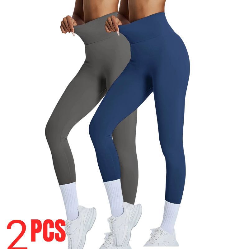 Two pairs of leggings, one gray and one blue, worn by a person on a white background.