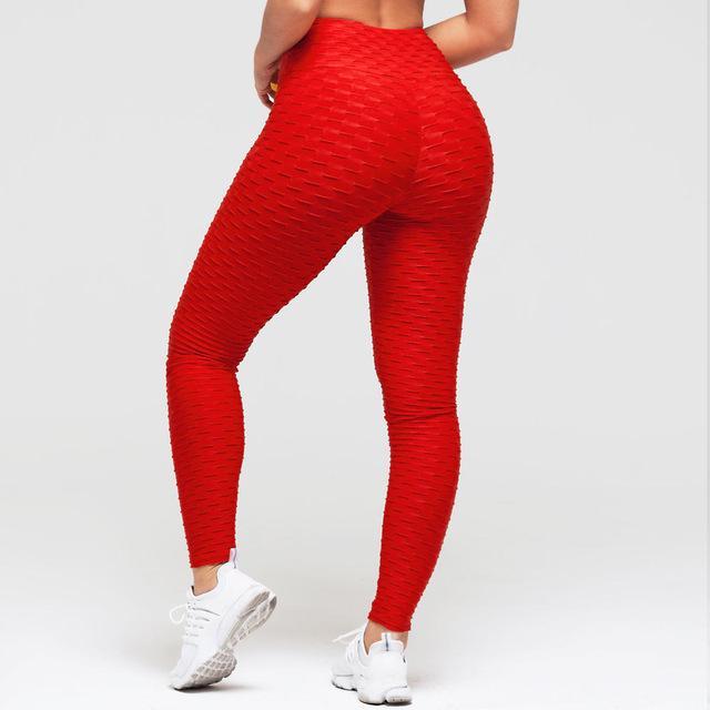 Red leggings worn by a person on a white background