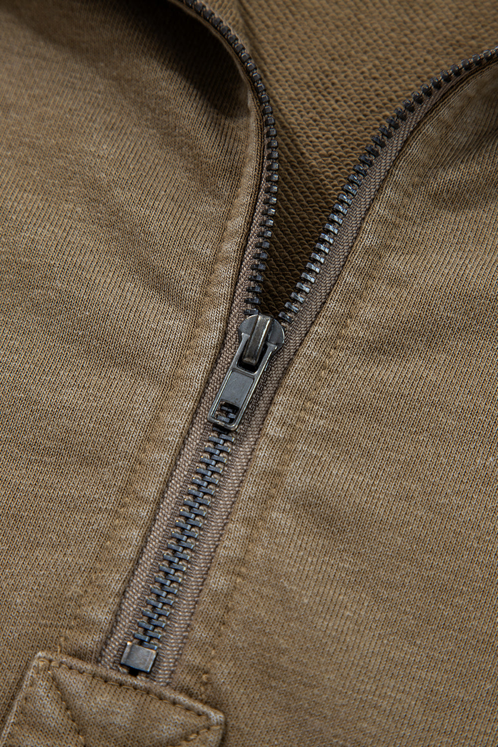 Close-up of a brown jacket zipper