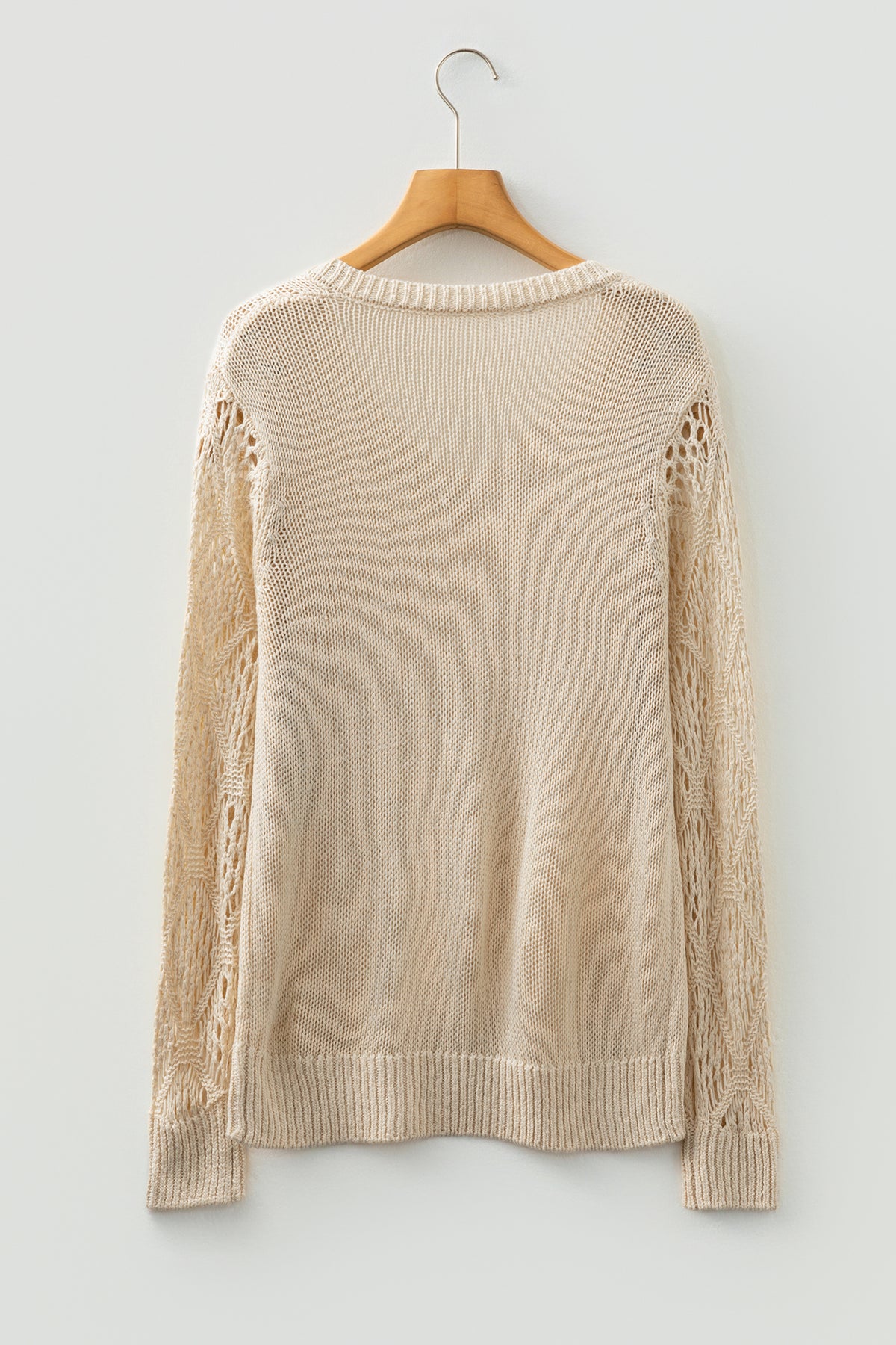 Beige Women's Pointelle Knit V-Neck Sweater on a wooden hanger back view