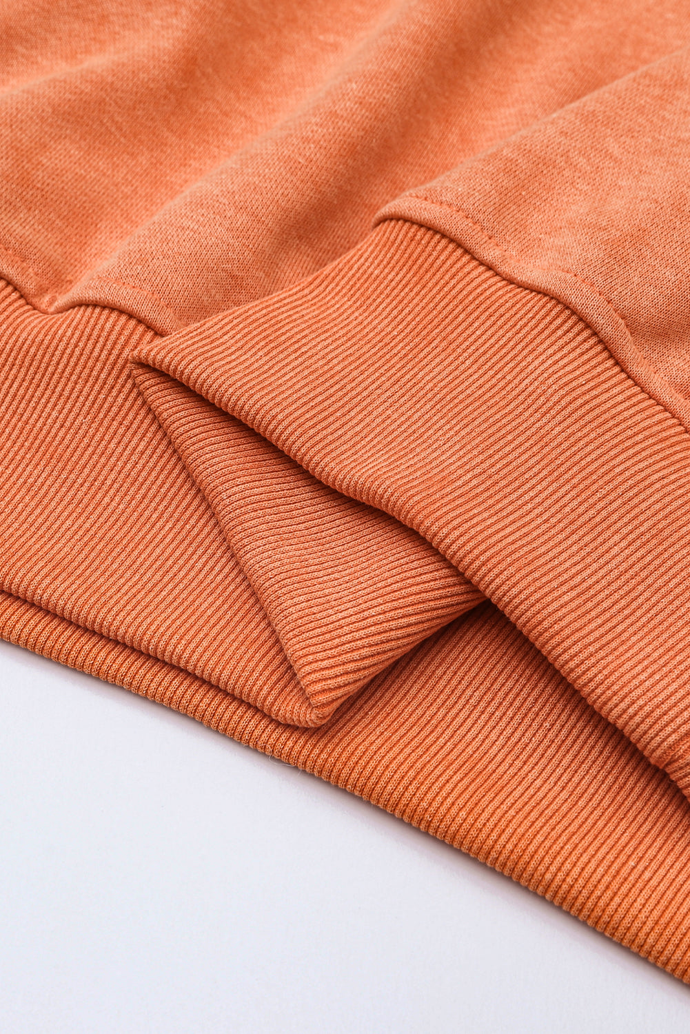 Close-up of orange fabric on a light gray background