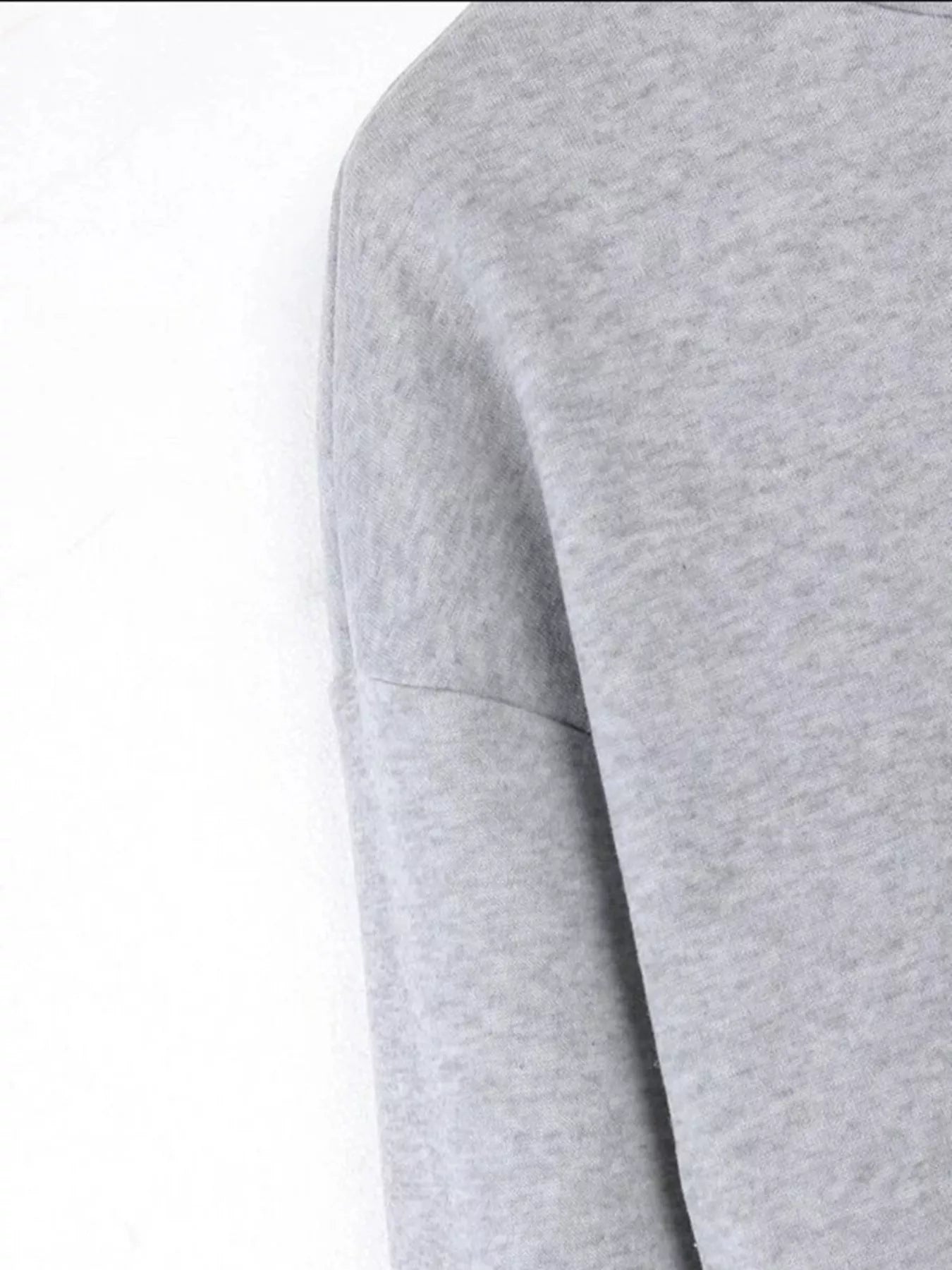 Close-up of a gray sweater on a white background