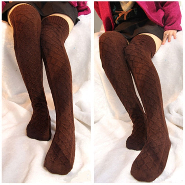 Brown knitted knee-high socks worn by a person on a white background