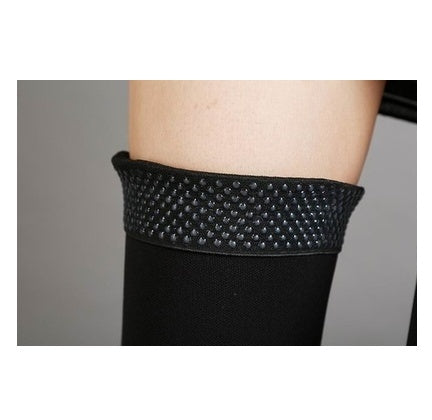 Black textured bandage on a person's arm against a neutral background