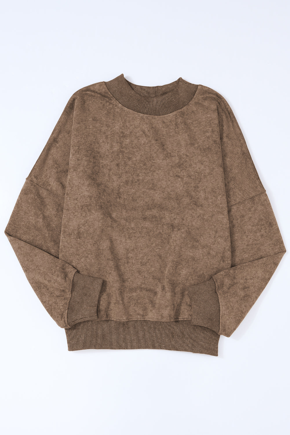 Brown sweater on a light blue background