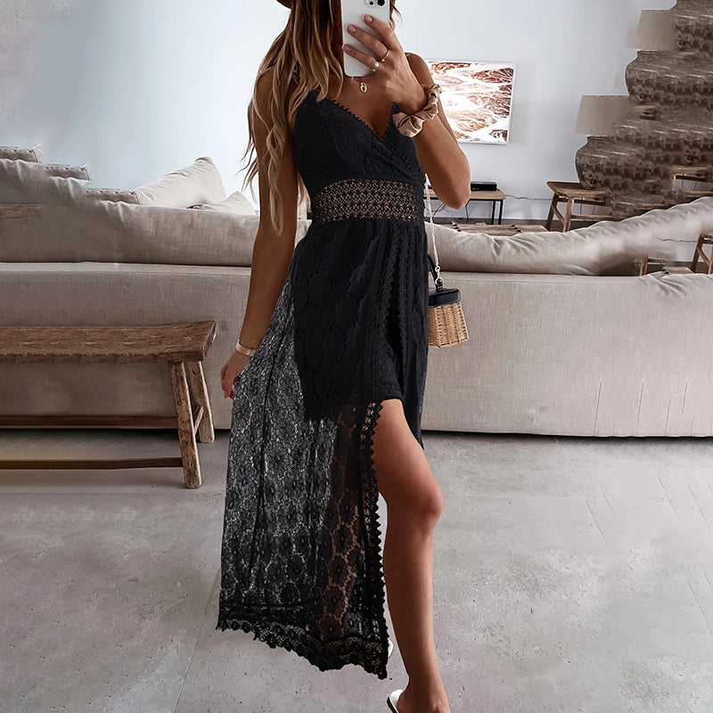 Woman taking a mirror selfie wearing a black dress with lace details in a living room.