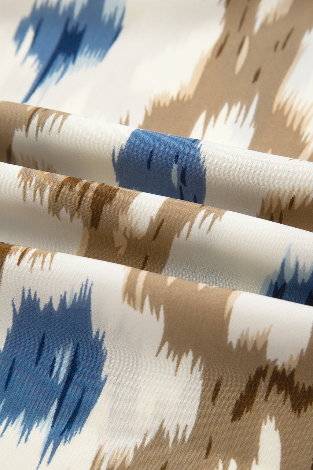 Close-up of fabric with blue and brown abstract pattern fabric detailed view