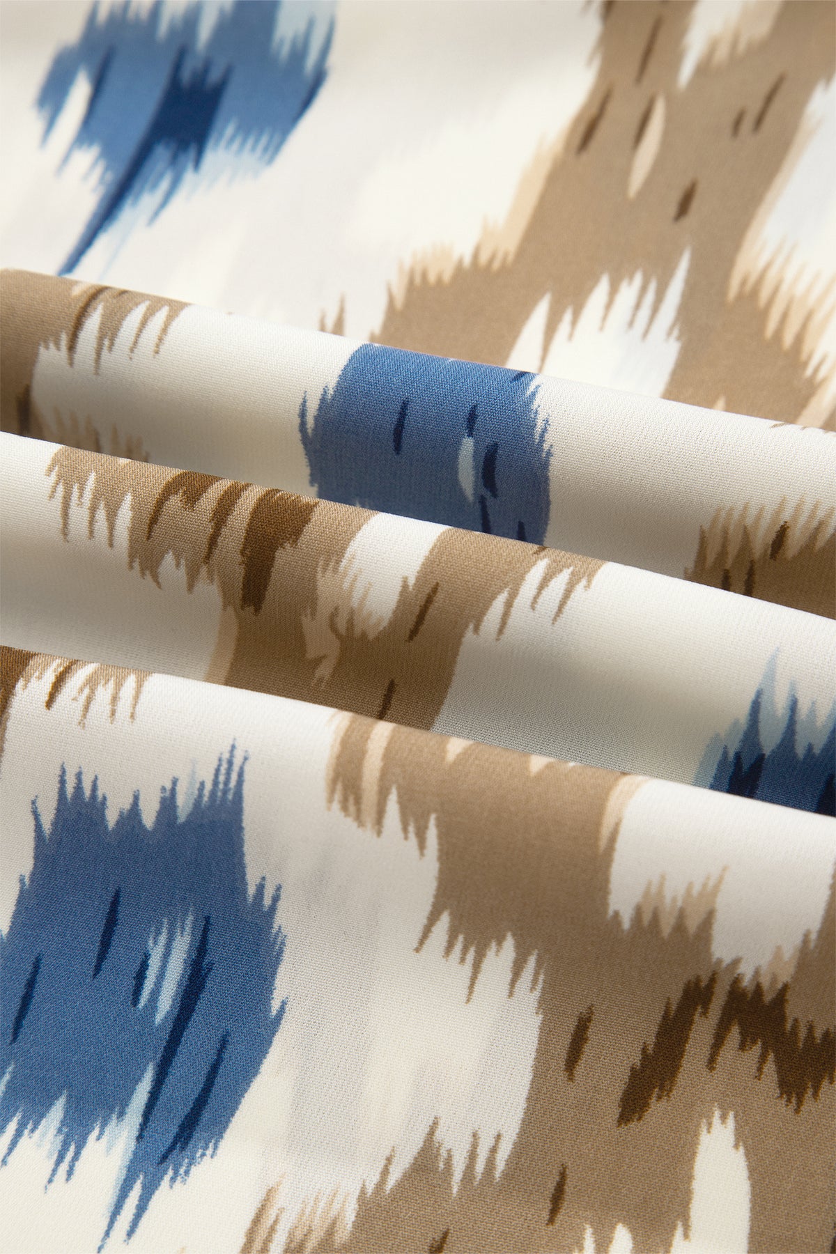 Close-up of fabric with blue and brown abstract pattern fabric detailed view