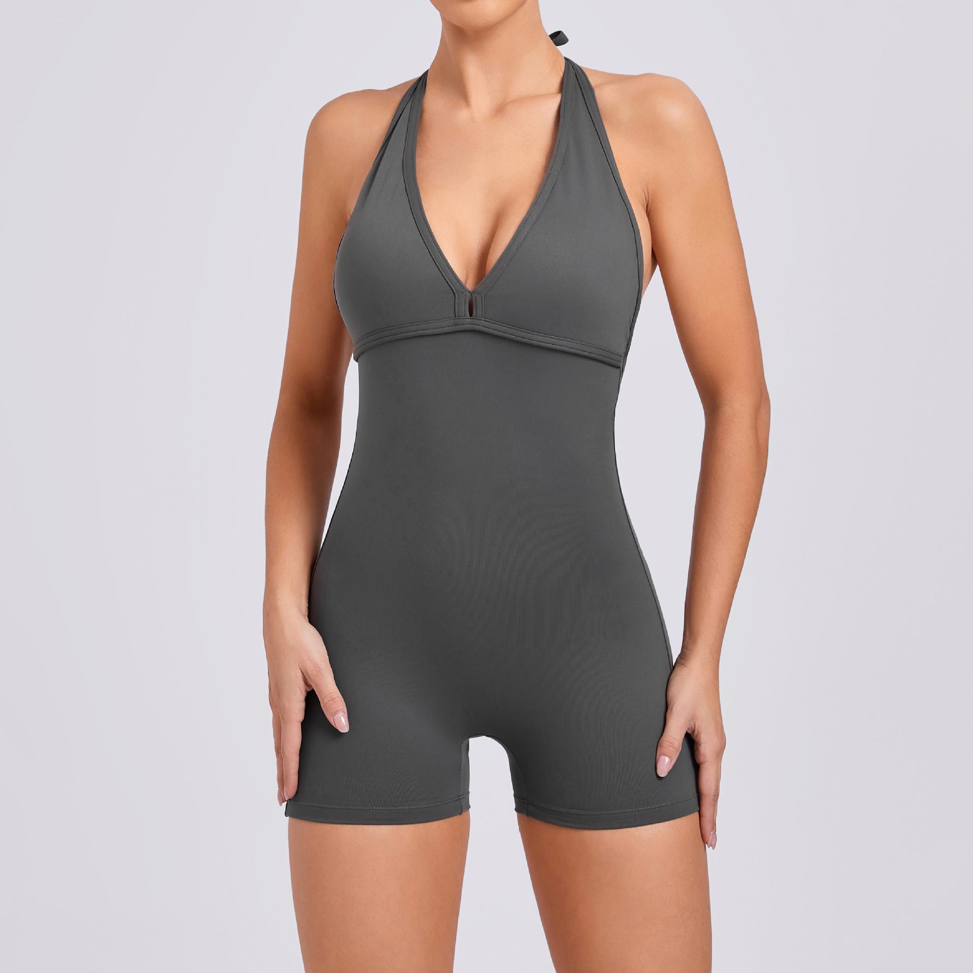 Gray bodysuit worn by a model on a light gray background