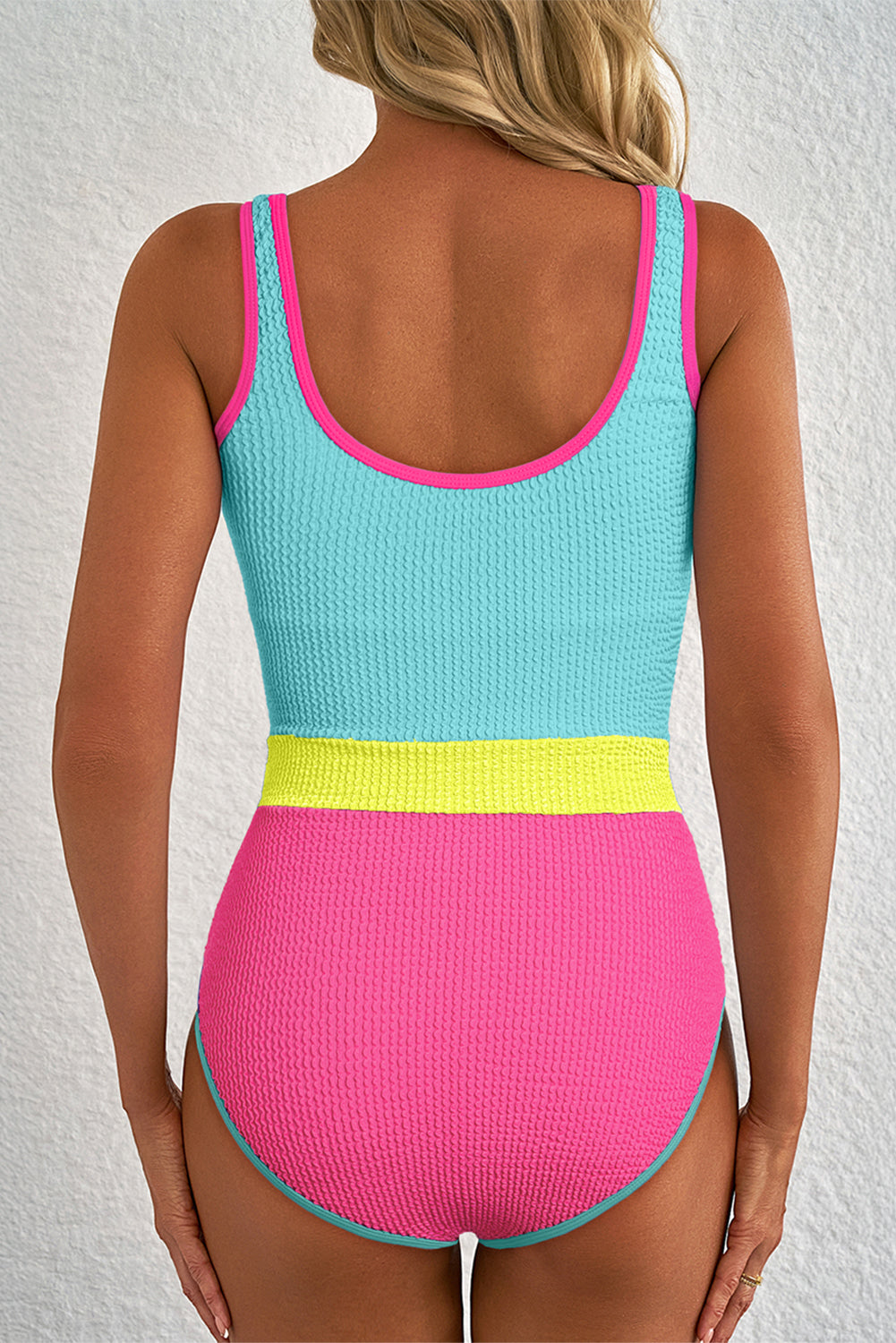 Multicolored swimsuit with pink, yellow, and blue on a white background