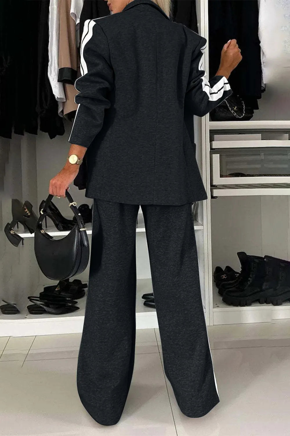 Person wearing a black suit in a clothing store setting
