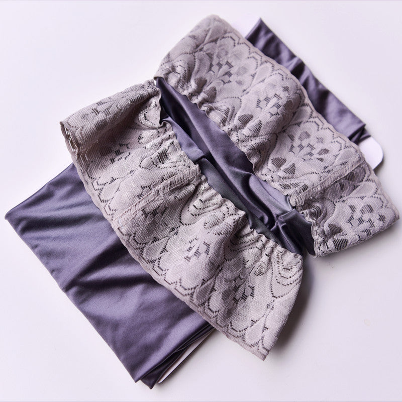 Folded lace fabric with a black plastic clip on a white background