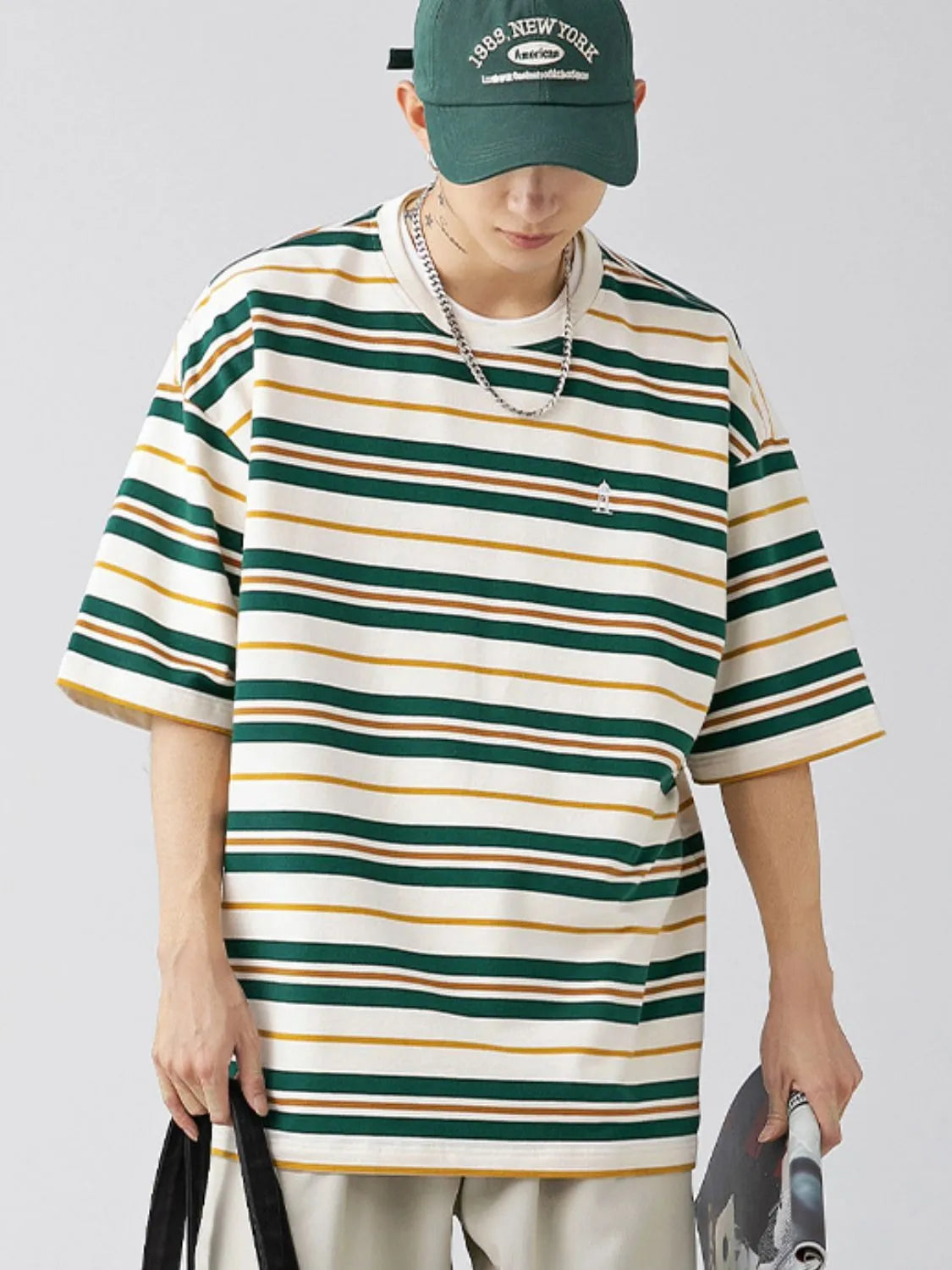 Male model wearing a dark green urban short sleeve stripe t-shirt 