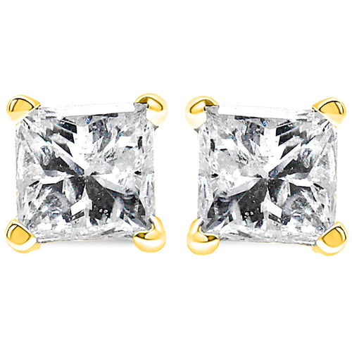 Pair of diamond stud earrings with gold prongs on a white background