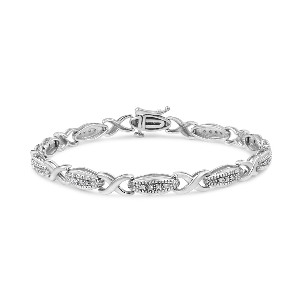 Silver bracelet with intricate design on a white background