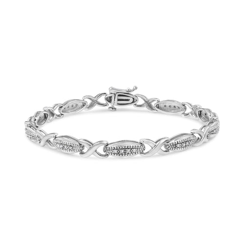 Silver bracelet with intricate design on a white background