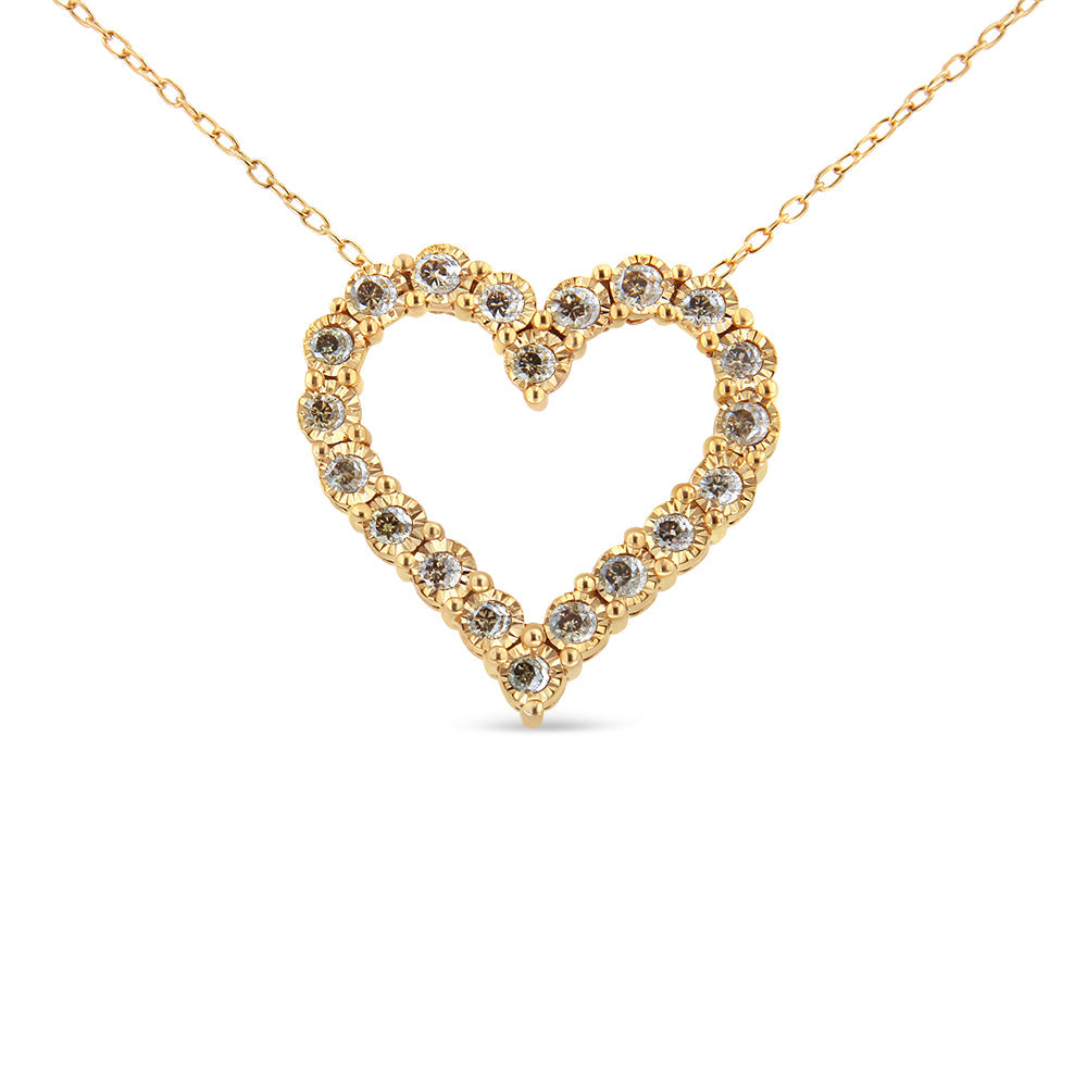 Gold heart-shaped necklace with embedded diamonds on a white background