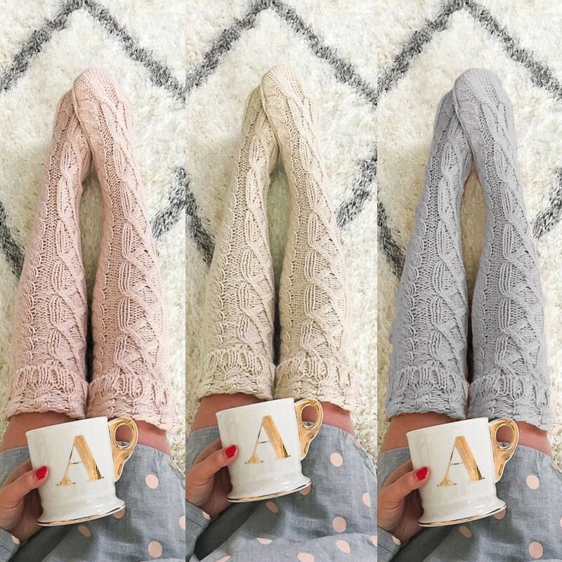 Three pairs of knitted leggings in pink, beige, and gray held by hands with mugs featuring the letter 'A'.
