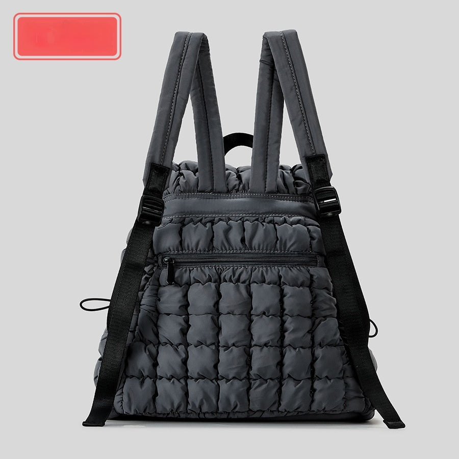 Gray quilted backpack on a light gray background