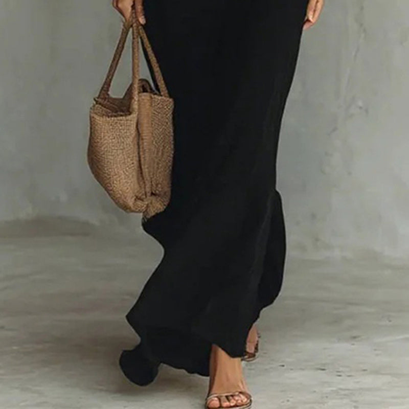 Person holding a woven bag with a neutral background