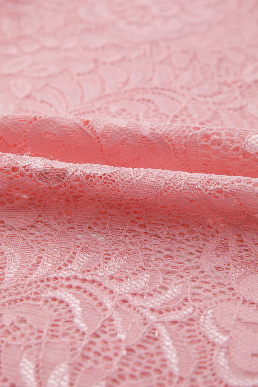Close-up of pink lace fabric with intricate patterns