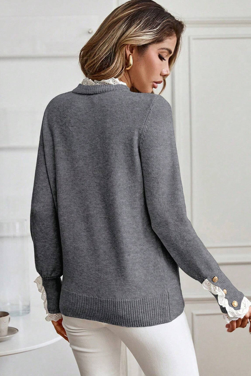 Model wearing a gray white lace-trim with white lace trim sleeves and neckline. Back view.
