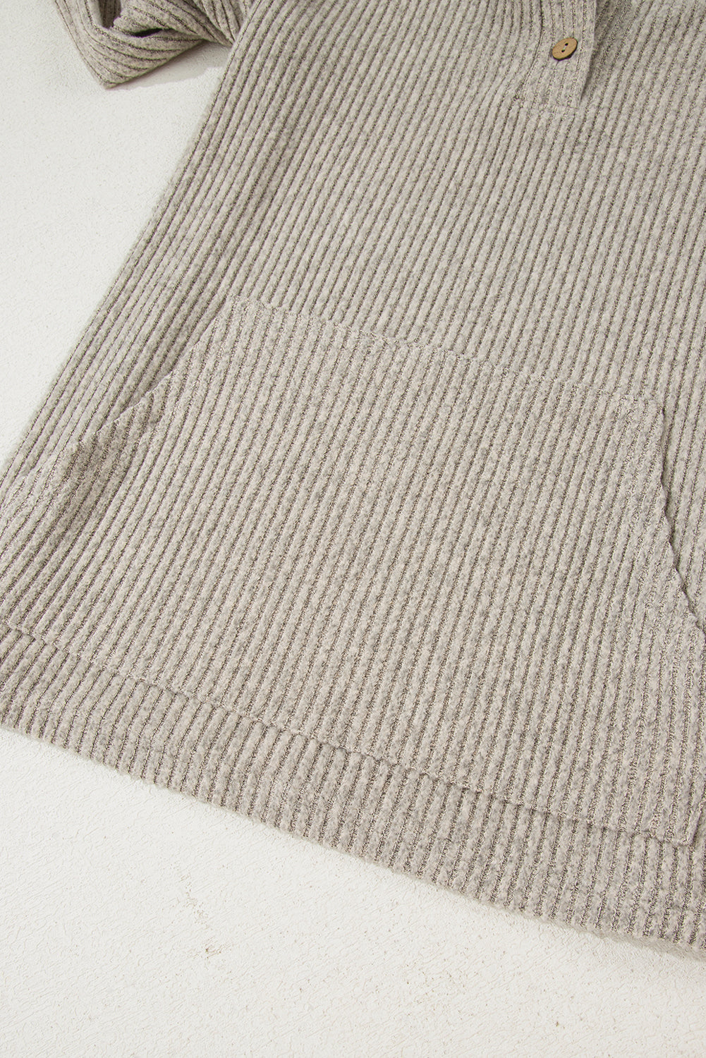 Close-up of a beige corduroy shirt on a white background