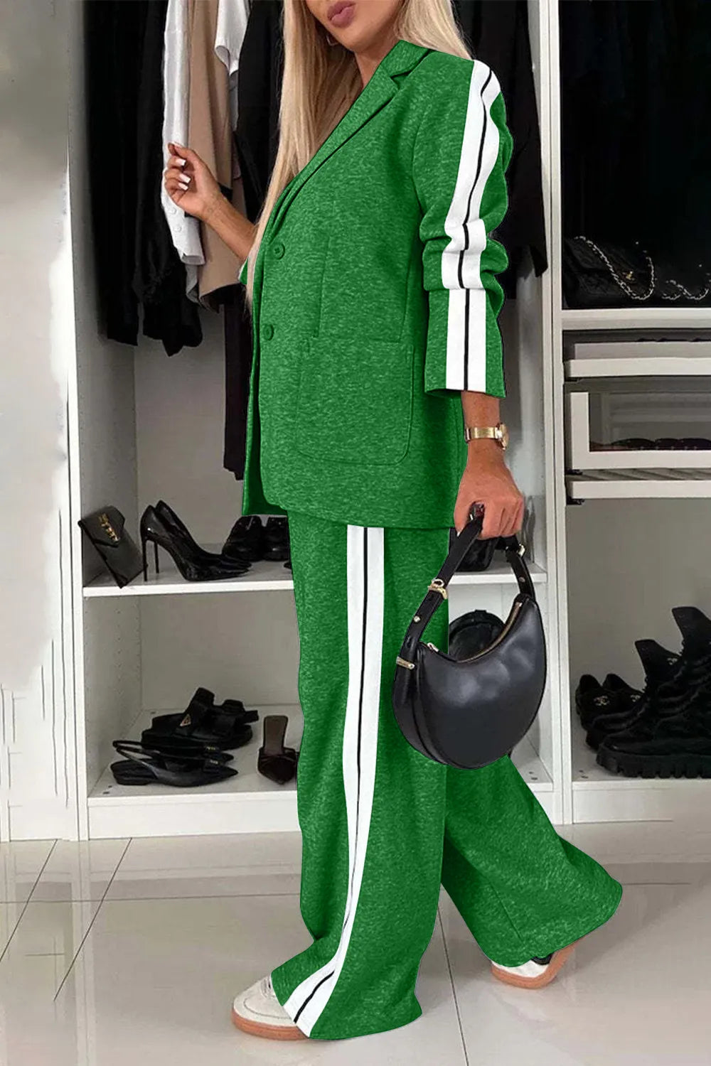 Woman wearing a green outfit with white stripes in a room with shoes on shelves.