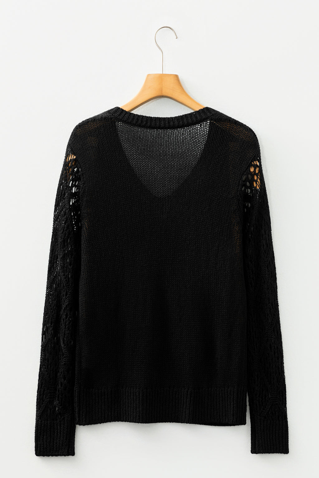 Black Women's Pointelle Knit V-Neck Sweater with hollow knit sleeves on a wooden hanger back view