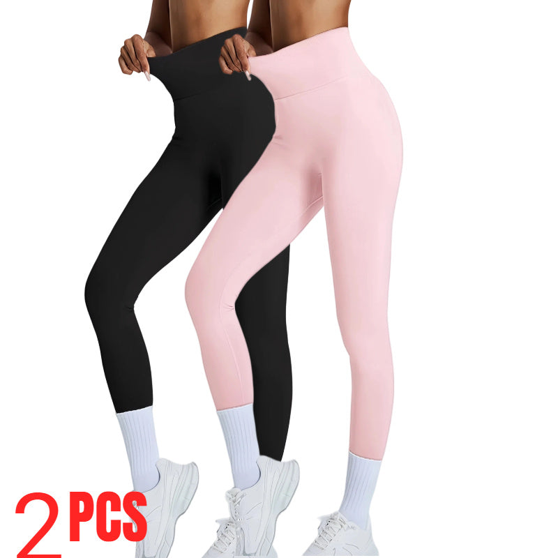 Two pairs of leggings, one black and one pink, worn by a person on a white background.