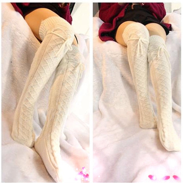 Beige knee-high socks worn by a person on a white background