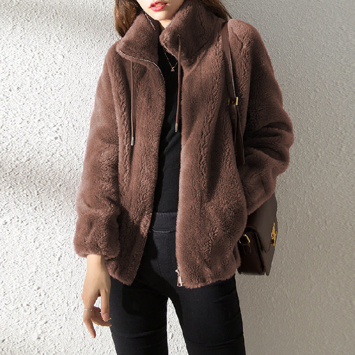 Brown textured jacket worn by a person against a neutral background