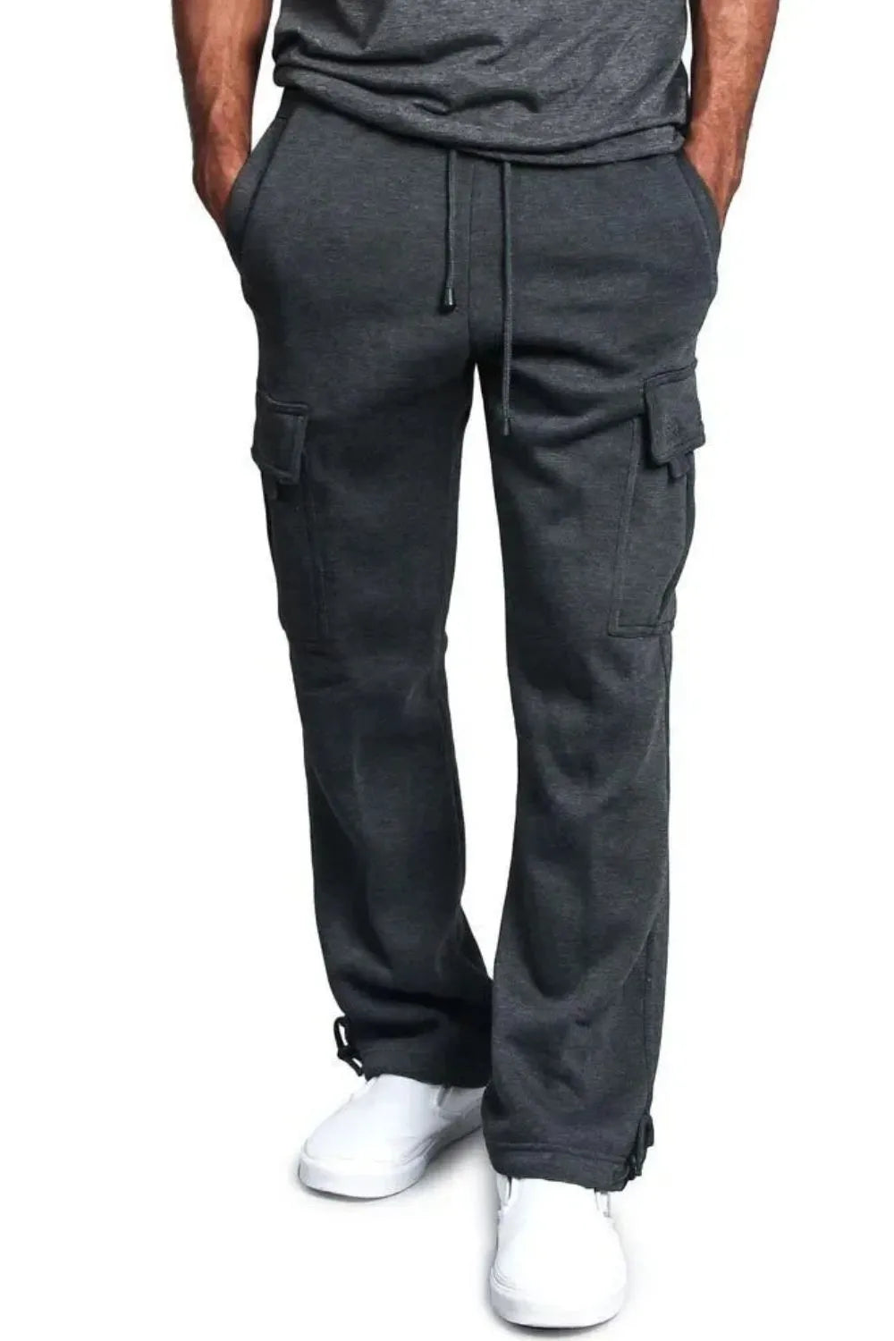 Male model wearing a pair of dark gray casual draw string cargo joggers pants 