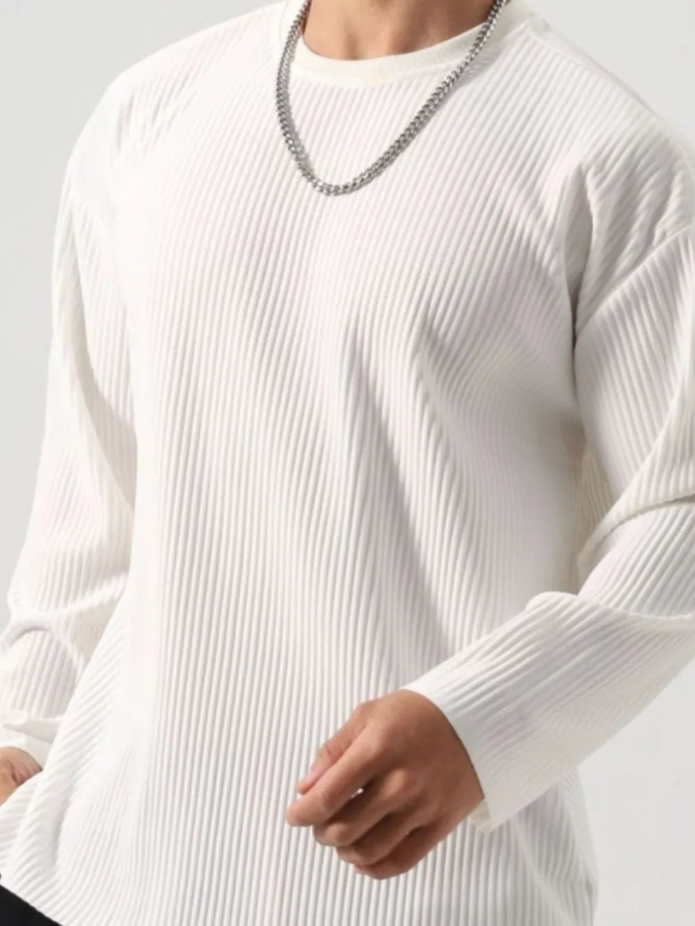 Person wearing a Men's Basic Ribbed Round Neck Long Sleeve T-Shirt with a chain necklace 