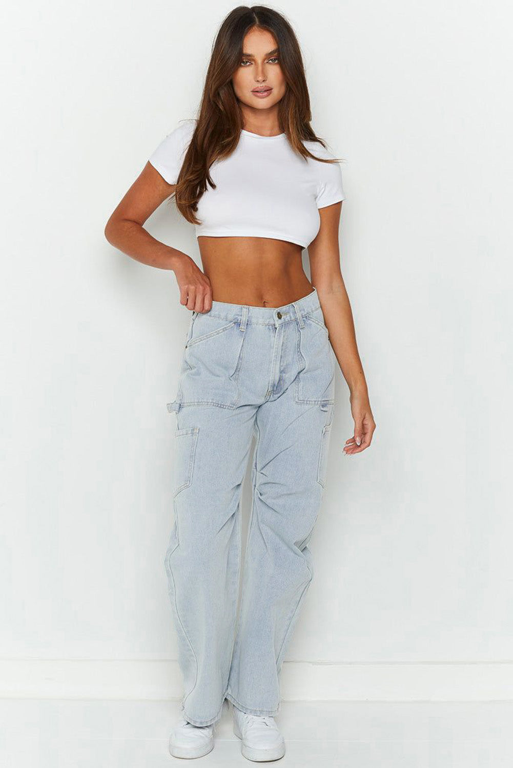 Model wearing a white crop top and Women's Y2K Multi-Pocket Jeans.