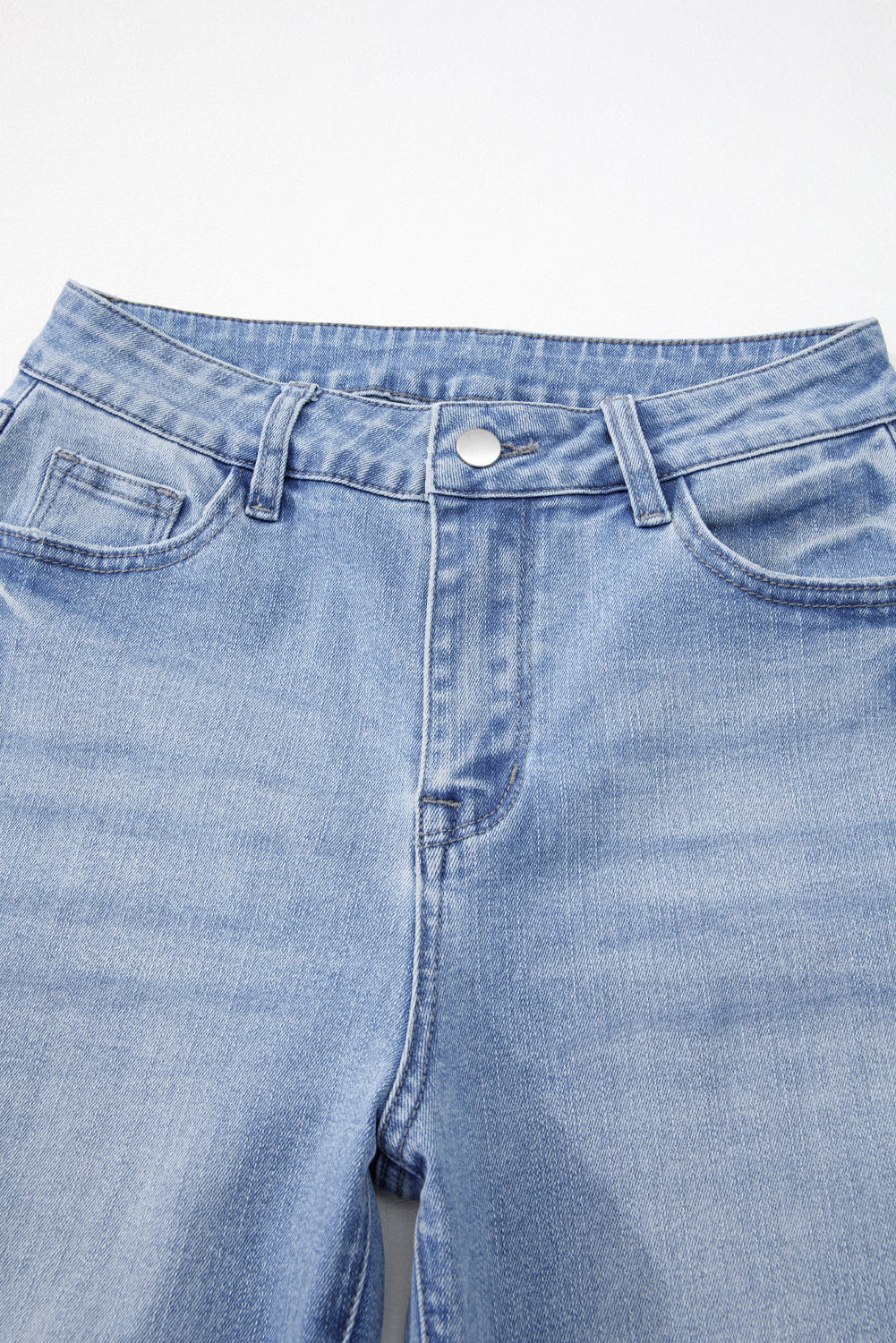 Close-up of blue jeans on a white background