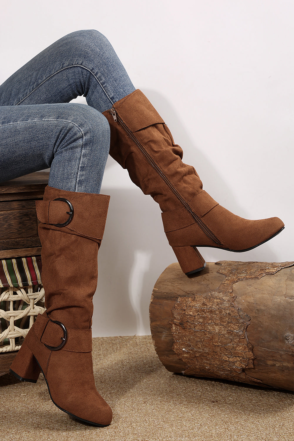 Brown knee-high boots worn with blue jeans side view