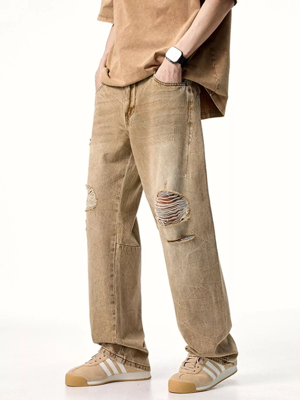 Male model wearing a pair of Men's Camel Brown Distressed Relaxed Fit Jeans side angle view
