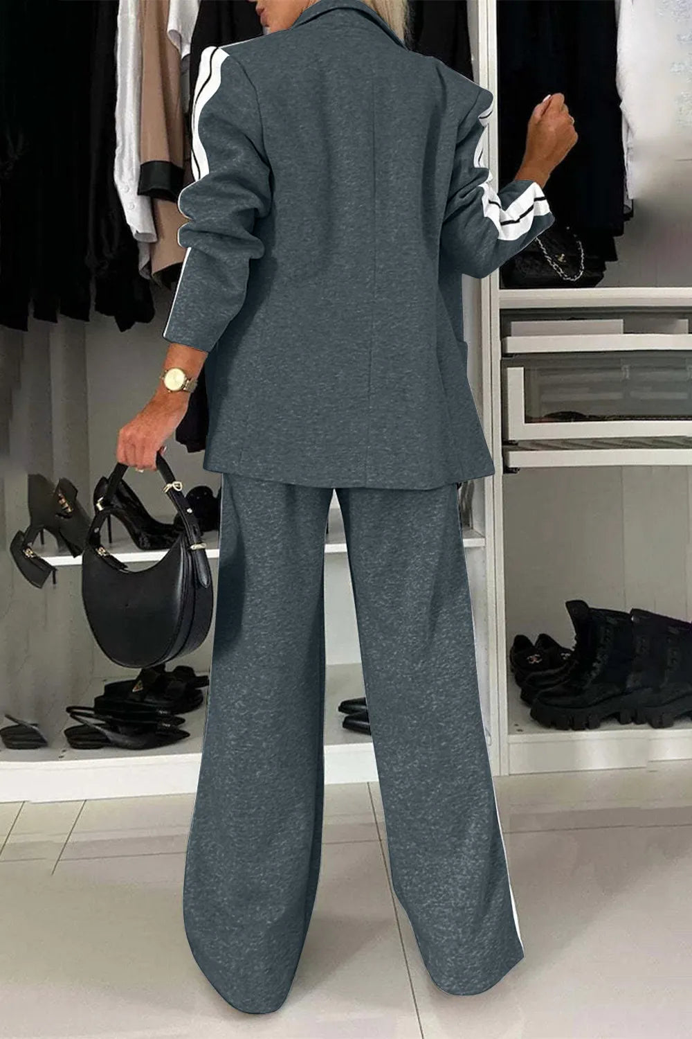 Person wearing a gray suit in a clothing store setting