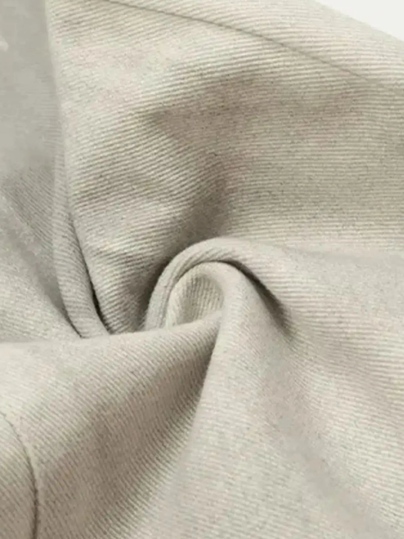 a pair of vintage washed off white jeans fabric close up