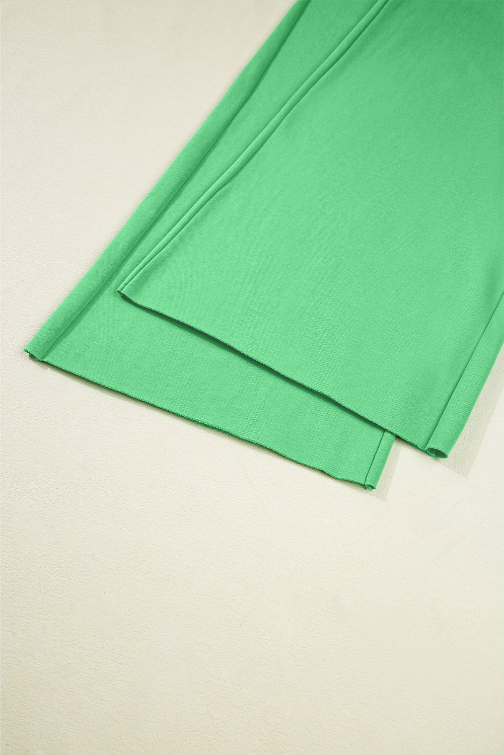 Green fabric on a beige background