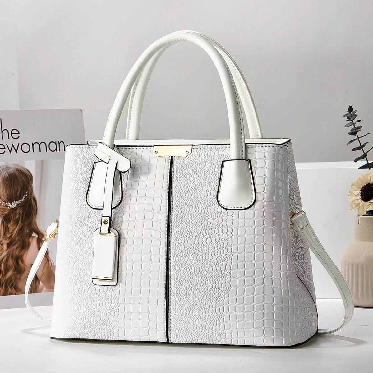White textured handbag on a light background