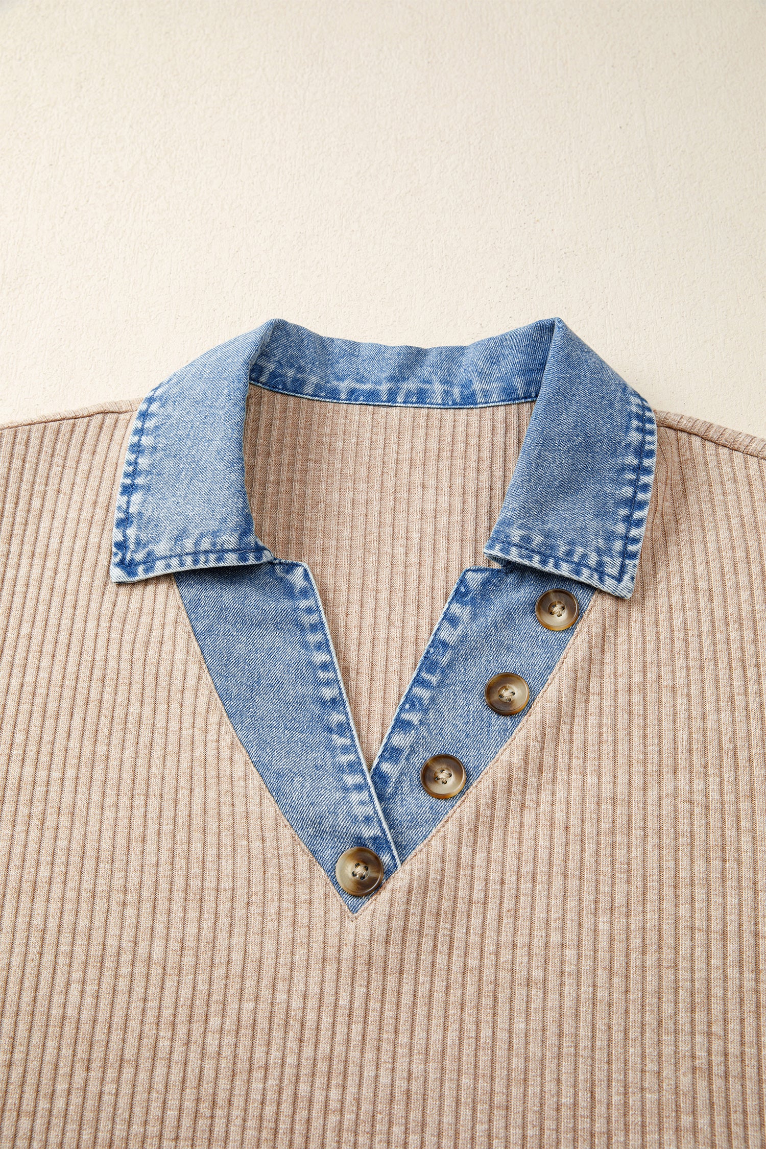 Denim collar with buttons on a beige background