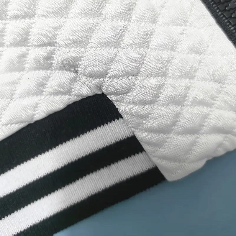 Close-up of a textured white surface with black and white stripes.