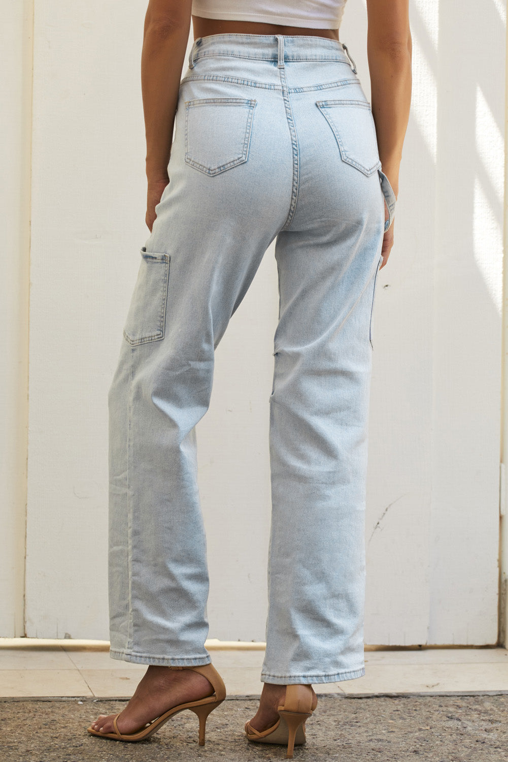 Women's Y2K Multi-Pocket Jeans by a model showing the jeans from the back view