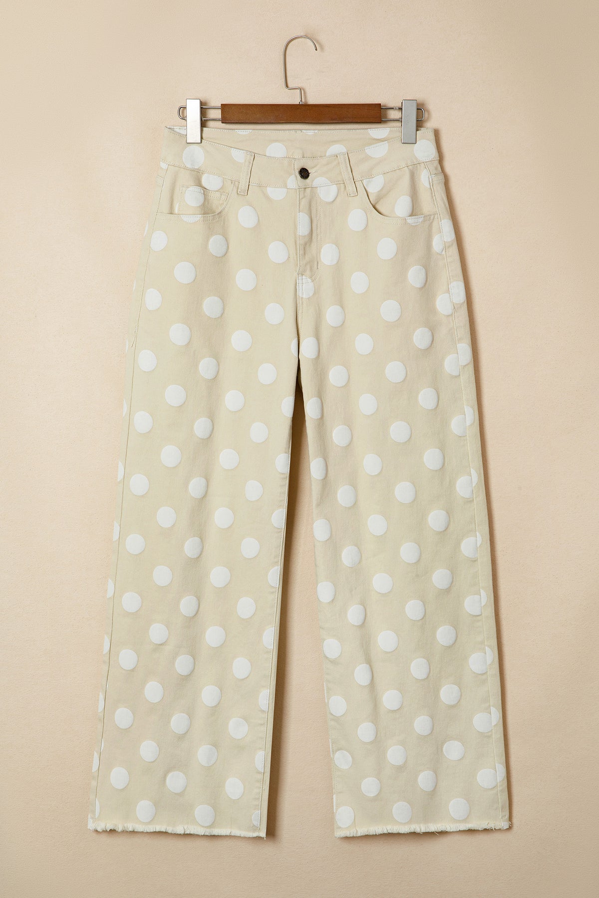 Beige pants with white polka dots on a beige background front 