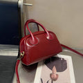Red handbag on a magazine with a blurred background