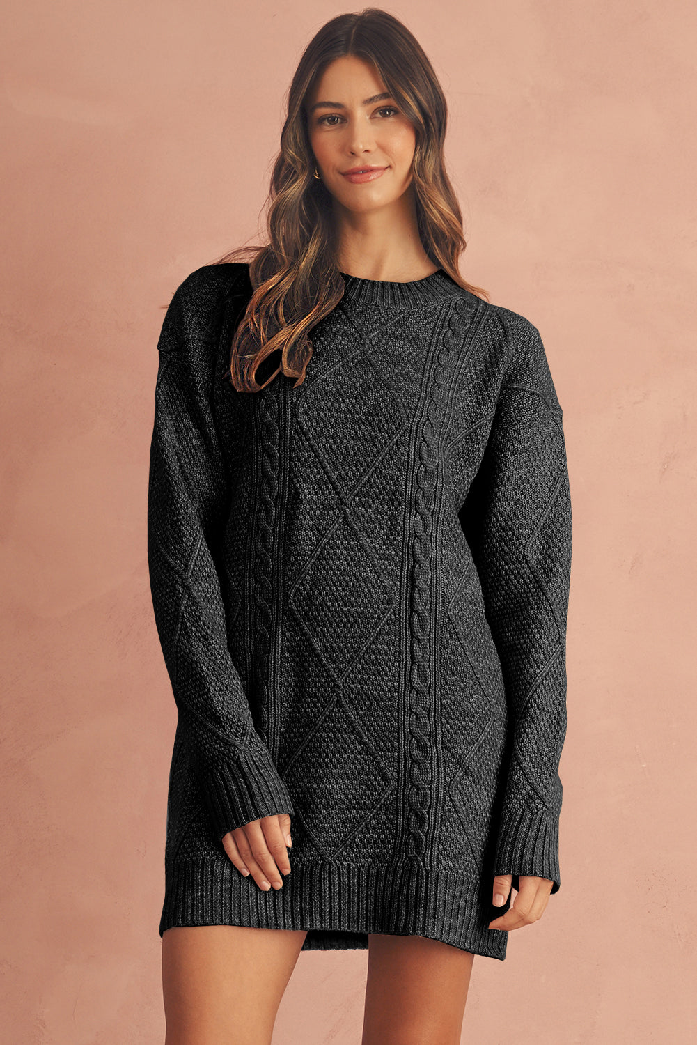 Woman wearing a dark gray/black cable knit sweater dress 