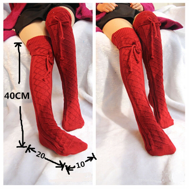 Red knitted knee-high socks with measurements on a white background